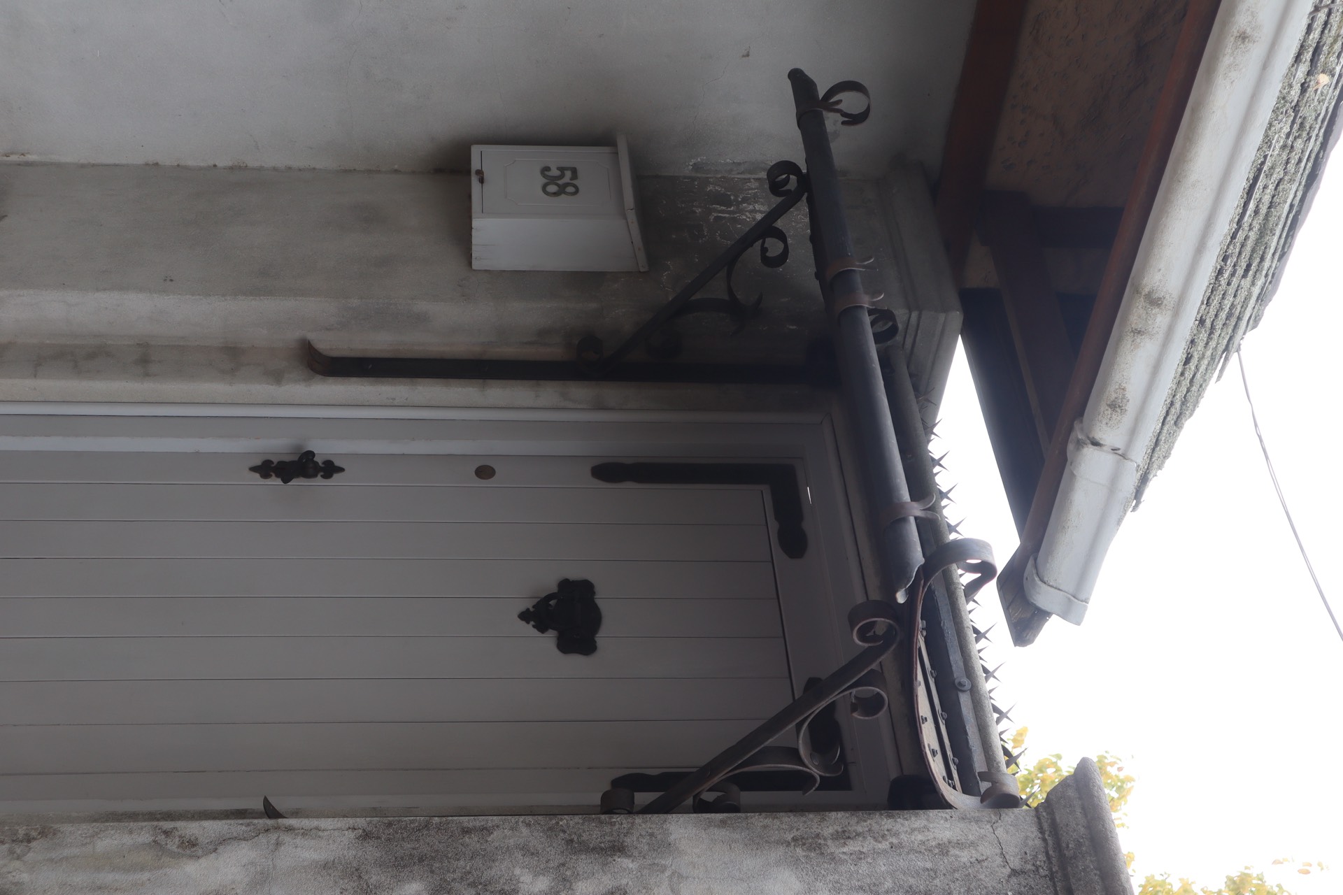 Ornate entrance canopy with artistic metalwork