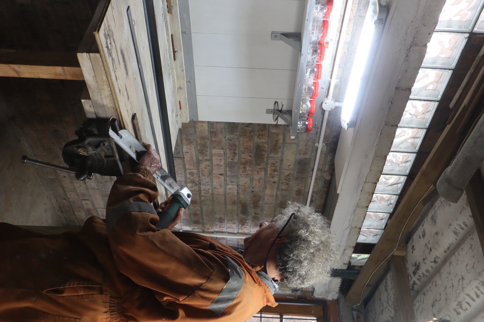 Ant crafting custom metalwork in his workshop